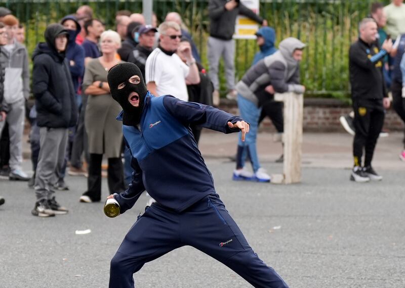 A youngster throws a bottle towards gardai officers during the incident in Coolock, north Dublin