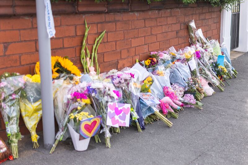 Members of the public have left floral tributes at the scene in memory of the victims