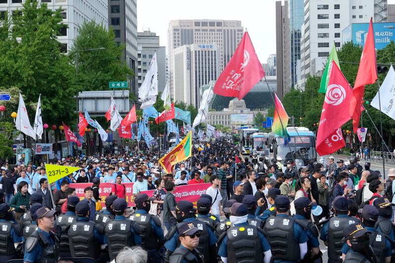 Members of the Korean Confederation of Trade Unions march during a rally on May Day (Ahn Young-joon/AP)