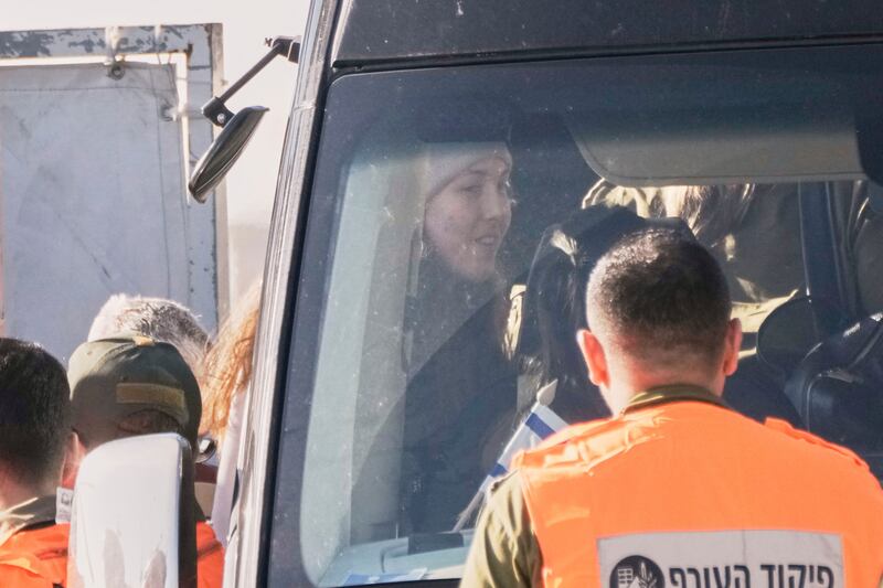 Israeli soldier Naama Levy, who was kidnapped by Hamas, gets on a bus after she and three other Israeli female soldiers were released by Hamas (Leo Correa/AP)