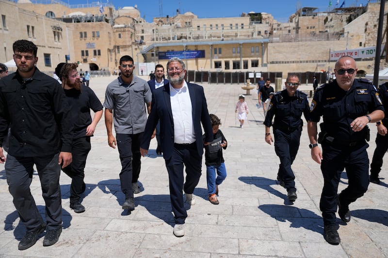 Israel’s far-right national security minister Itamar Ben-Gvir, centre, flanked by his security detail, approaching the entrance to Jerusalem’s most sensitive holy site (Ohad Zwigenberg/AP)