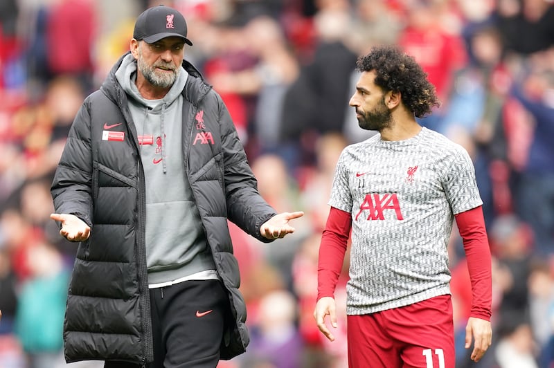 Klopp (left) and Salah speaking ahead of a Liverpool match last season