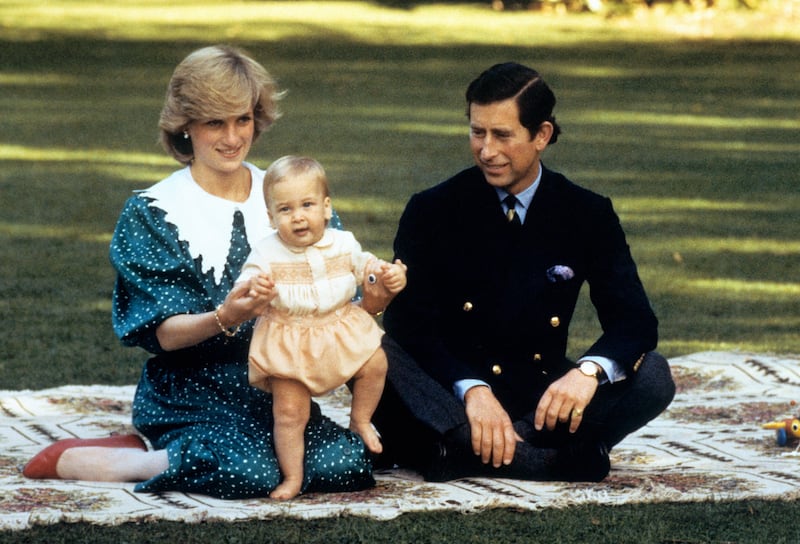 Diana and Charles amuse baby Prince William in the grounds of Government House in Auckland, New Zealand