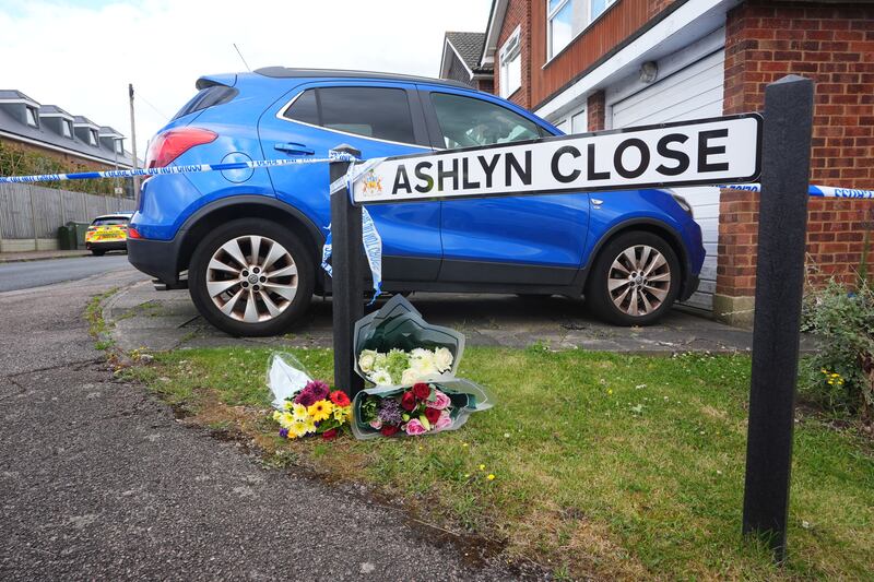 Flowers left near the scene in Ashlyn Close, Bushey, where the wife and two daughters of a BBC sports commentator have been killed in a crossbow attack