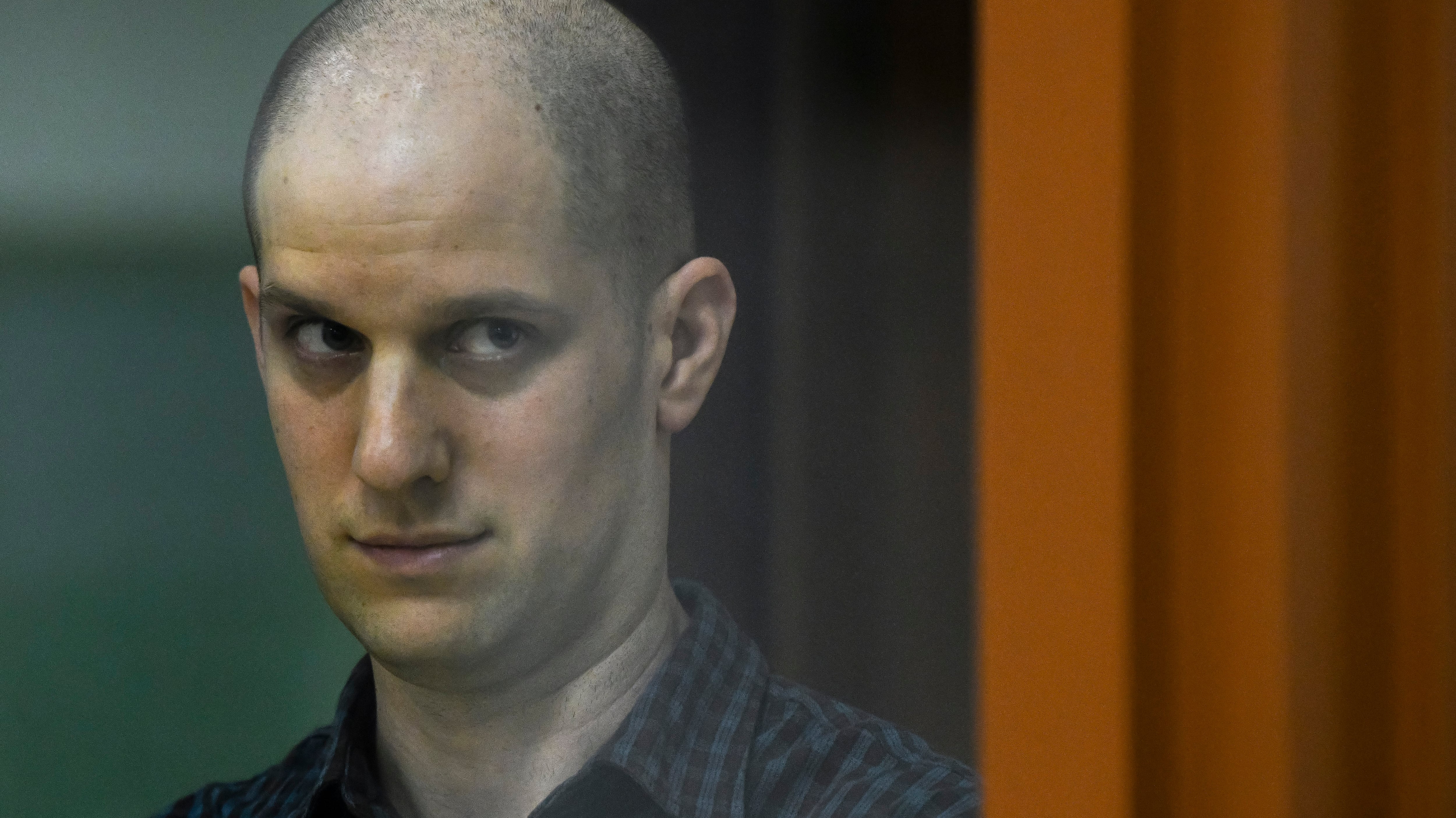Wall Street Journal reporter Evan Gershkovich stands in a glass cage in a courtroom in Yekaterinburg, Russia (AP)