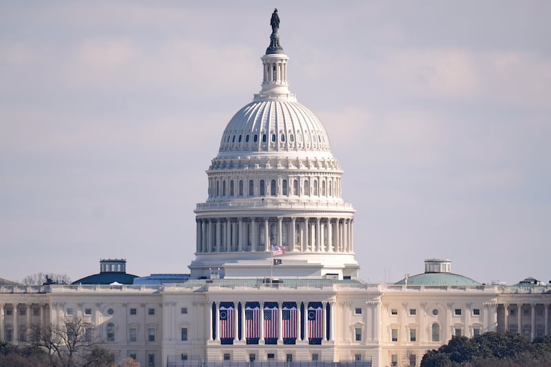 The US flag at the US Capitol is at full height on the day of the 60th Presidential Inauguration in Washington (Mike Stewart/AP)