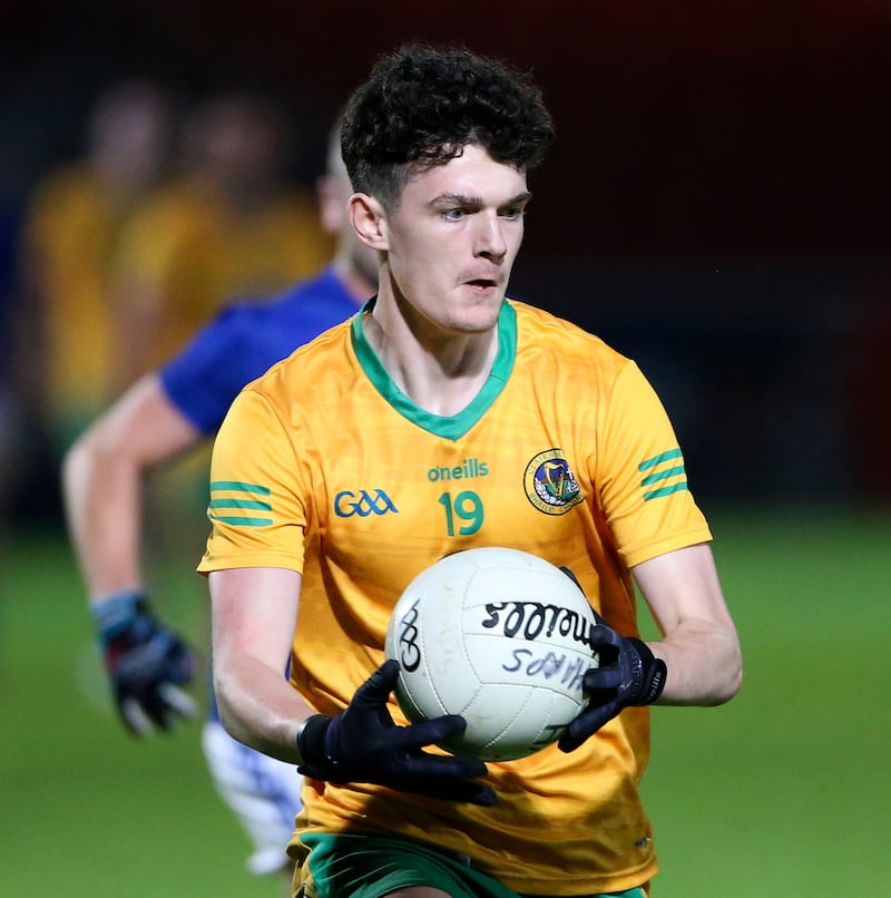 A man in a yellow football jersey holding a ball