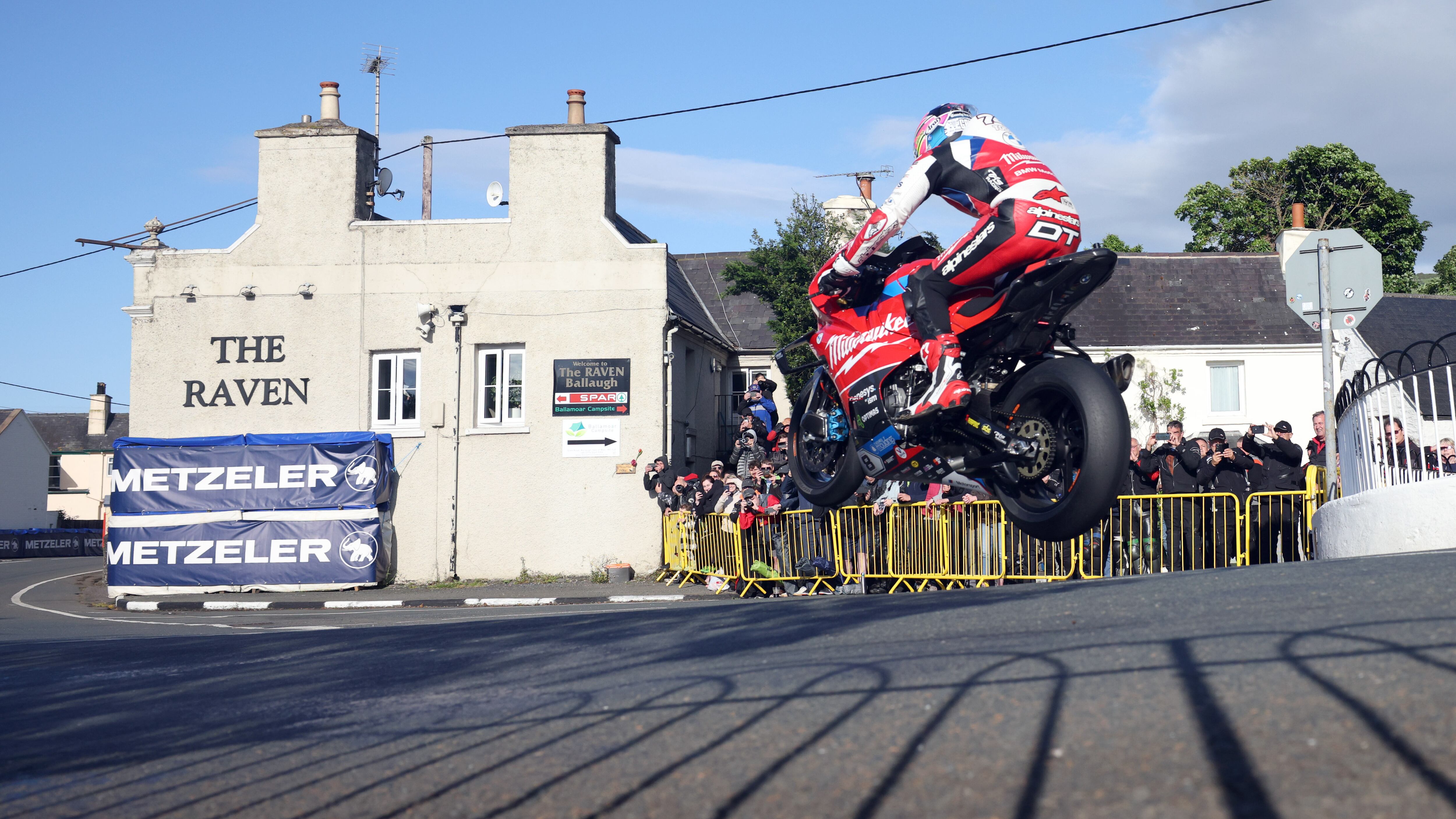Davey Todd riding a motorbike through the air in Ballaugh in the Isle of Man during the 2024 TT practice session
