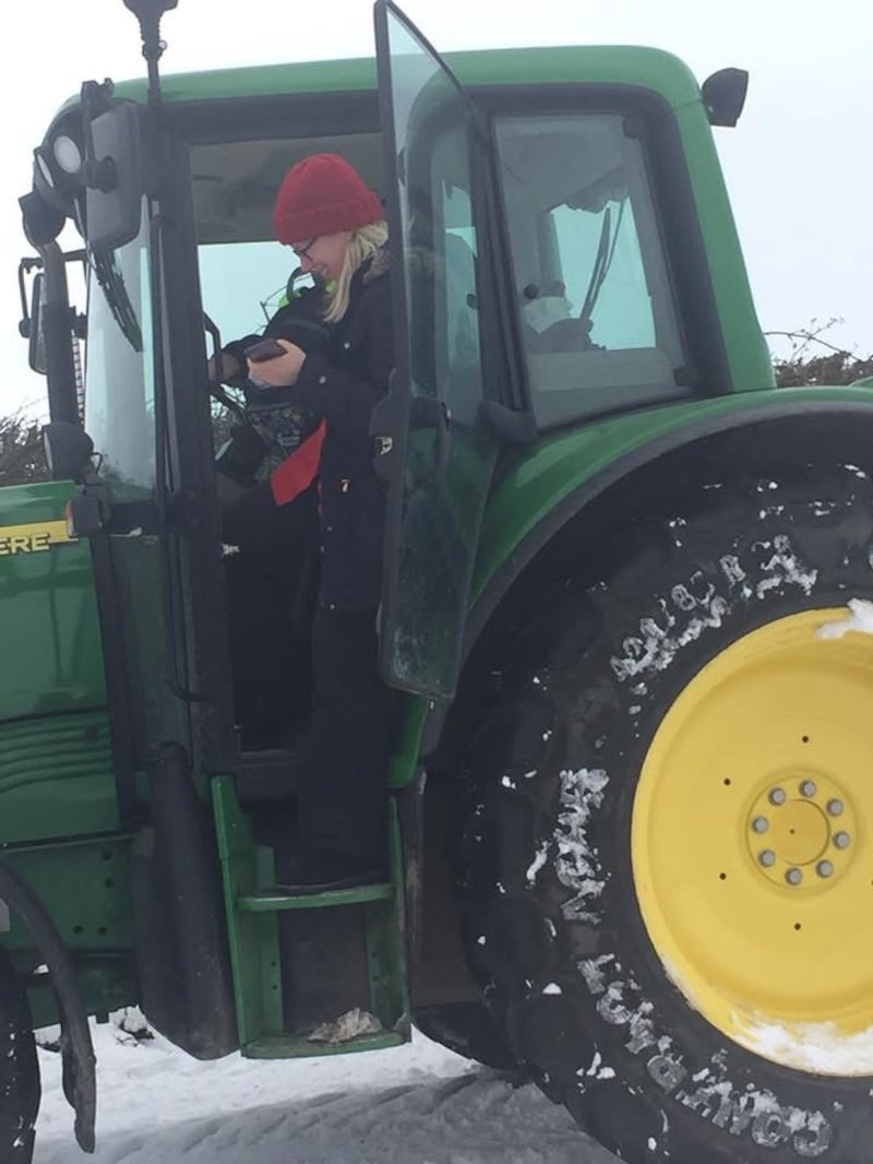 District nurse team manager Leanne Rooney getting out to visit a patient in snowy weather with the help of a tractor.