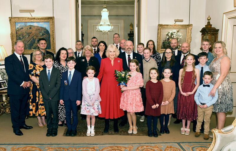 The Queen poses with fund members and beneficiaries during The Colonel’s Fund event at Clarence House