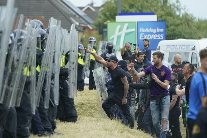 Morgan Hardy (centre, with sunglasses) was among three men jailed on Thursday for their roles in the rioting outside the Holiday Inn Express, in Rotherham