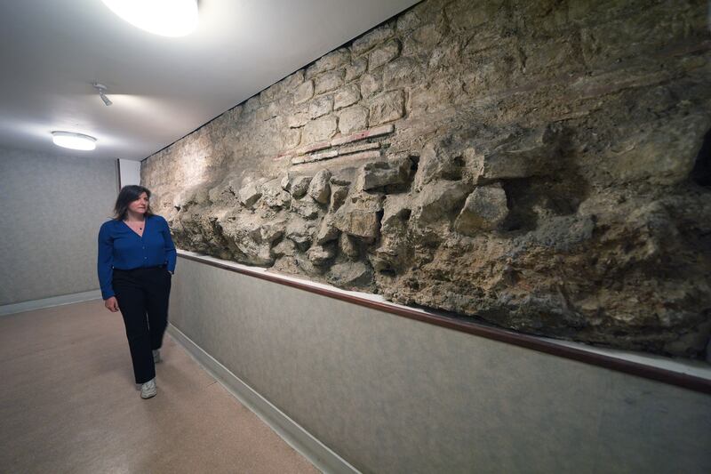 PA court reporter Emily Pennink views a section of the old Roman Wall which encircles the City of London and is among the foundations of the Old Bailey