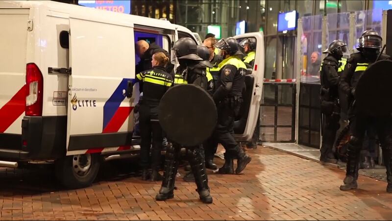 Police detain a man near the Ajax stadium (InterVision/AP)