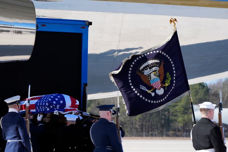 The flag-draped casket of former president Jimmy Carter is placed onto Special Air Mission 39 at Dobbins Air Reserve Base in Marietta, Georgia (Alex Brandon/AP)