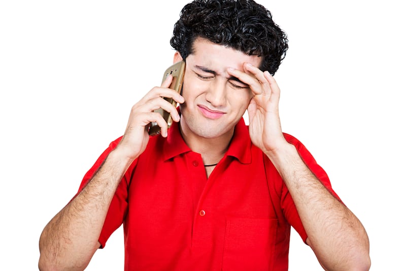 KX399R 1 Indian Young Man Headache Talking On Cell Phone Frustrated