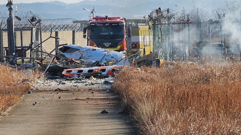 Fire engines work to extinguish a fire at the Muan International Airport (Maeng Dae-hwan/Newsis/AP)