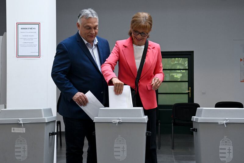 Hungarian Prime Minister Viktor Orban and his wife Aniko Levai cast their votes at a polling station in Budapest (Szilard Koszticsak/MTI/AP)