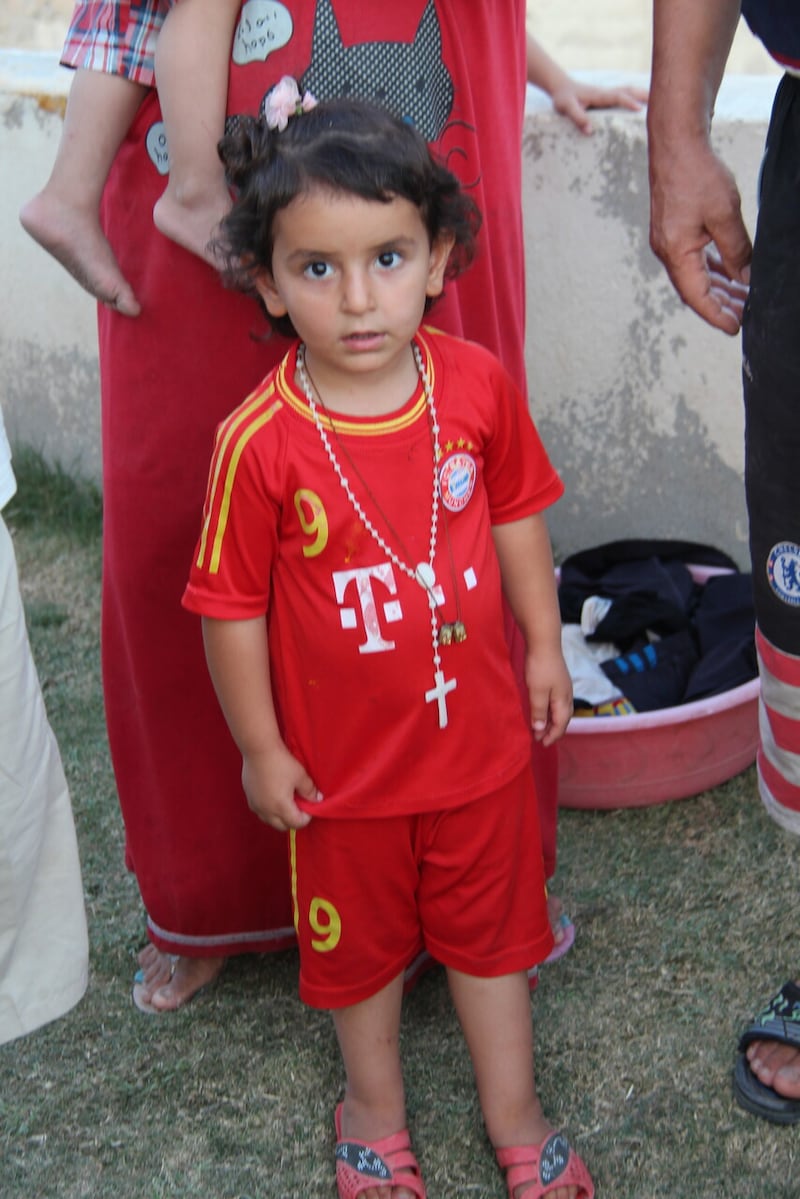 An internally-displaced Christian boy in 2014 just weeks after the ISIS invasion where his family had fled to the city of Duhok, in the Kurdish-administered region of Iraq. A decade later, almost half of Christians have returned to newly-reconstrued homes