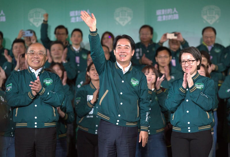 Taiwan President Lai Ching-te celebrates his election victory with running mate Bi-khim Hsiao, right, and supporters in Taipei (Chiang Ying-ying/AP)