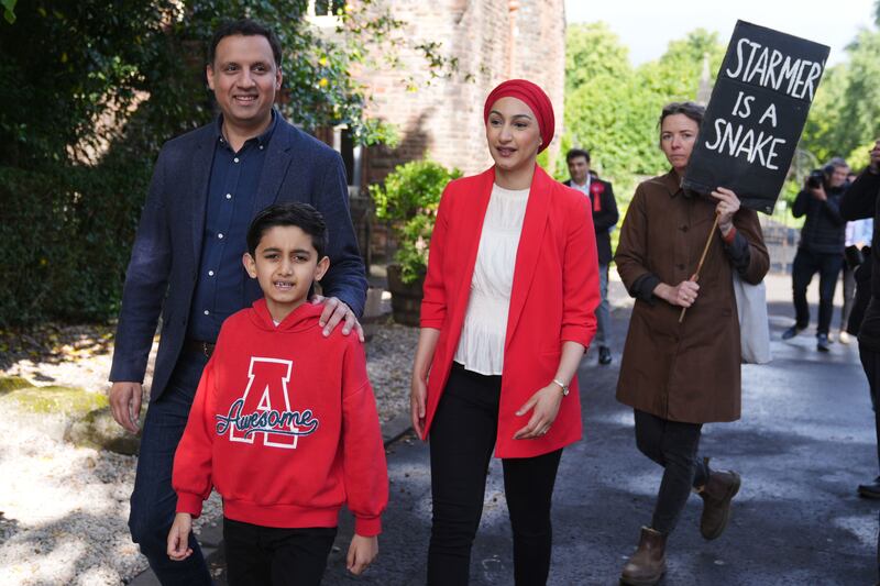 Scottish Labour leader Anas Sarwar, his wife Furheen and their son Aliyan were followed by a protester as they attended Pollokshields Burgh Halls in Glasgow to vote
