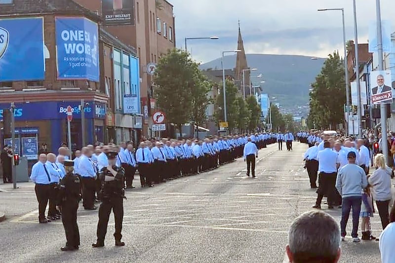 Hundreds of men in white shirts and black ties lined the route of a memorial parade for murdered UVF man Robert Seymour on the Newtownards Road