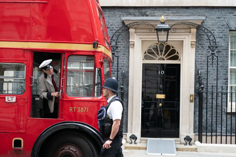 The pupils boarded a 1940s-style red double-decker bus outside Number 10 and were transported to HMS Belfast