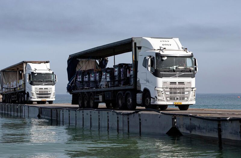 Trucks loaded with humanitarian aid cross the Trident Pier to the Gaza Strip (Staff Sgt Malcolm Cohens-Ashley/US Army/AP)
