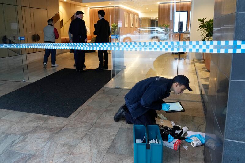 A suspect is believed to have smashed nine holes in the reinforced glass windows of the building in North Sydney (AP)