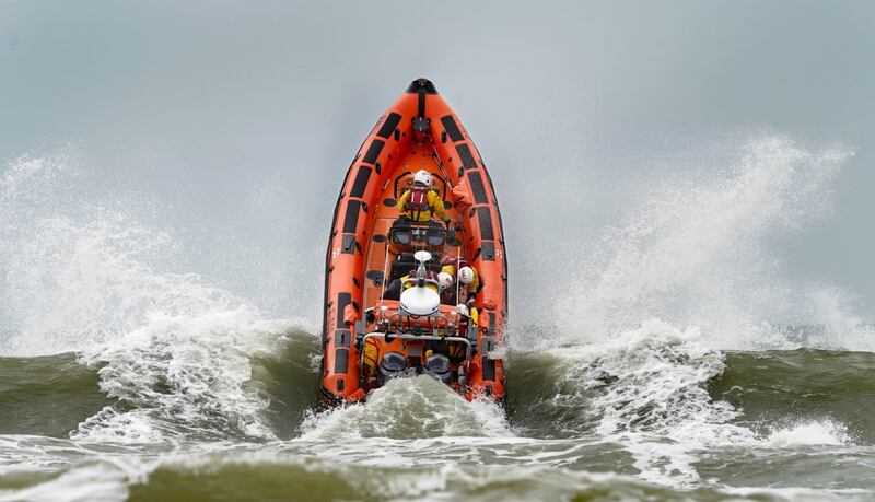 An RNLI lifeboat crashes through waves during a multi-agency exercise