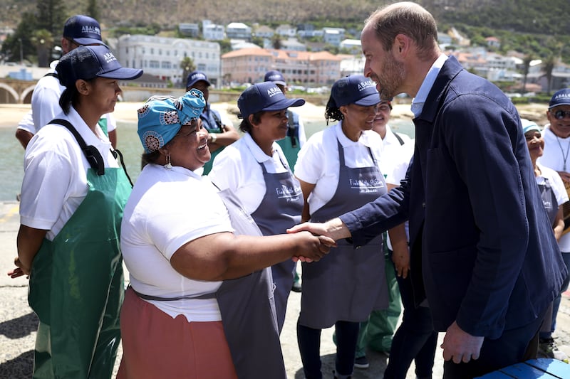 The Prince of Wales meeting local fishermen in Kalk Bay Harbour, Cape Town, to highlight the contributions of 2023 Earthshot finalist Abalobi