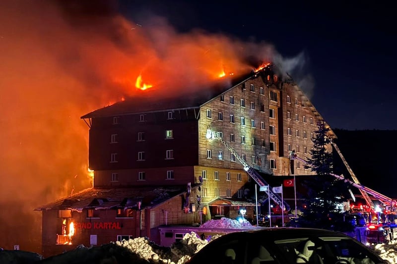 Firefighters work to extinguish a fire in a hotel at a ski resort of Kartalkaya