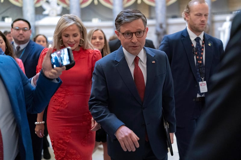 Speaker of the House Mike Johnson, accompanied by his wife Kelly Johnson, walks to the House Chamber before starting the 119th United States Congress at the Capitol in Washington (Jose Luis Magana/AP)