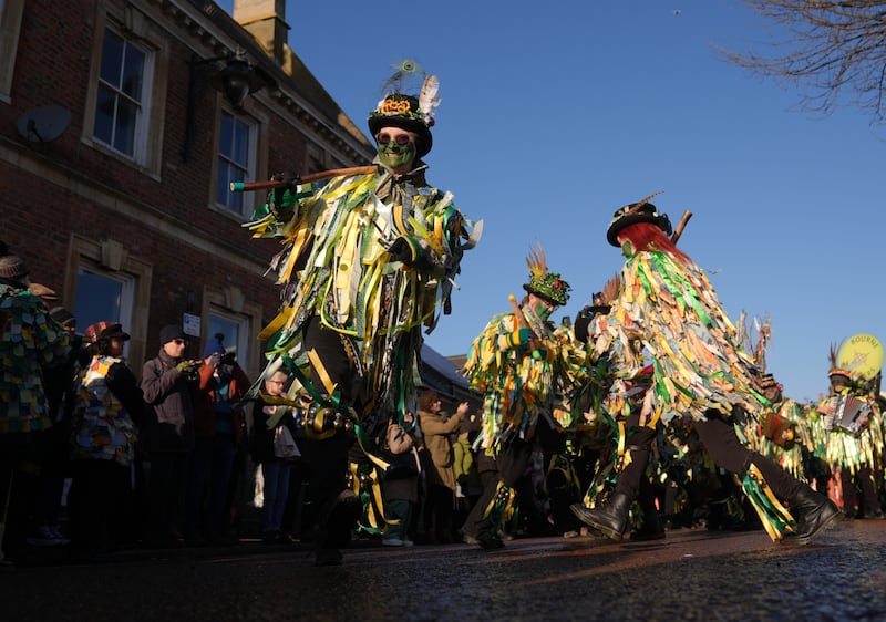 Members of the Bourne Borders dance group take part in the Whittlesea Straw Bear Festival in Whittlesea, Cambridgeshire