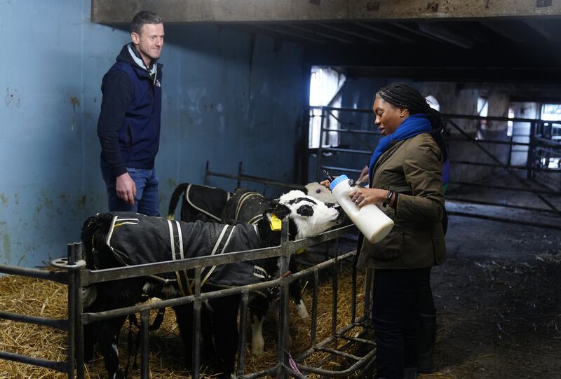 Kemi Badenoch with farmer Richard Davenport as she feeds calves during a visit to Top O The Town Farm in Broomhall near Nantwich, Cheshire (Peter Byrne/PA