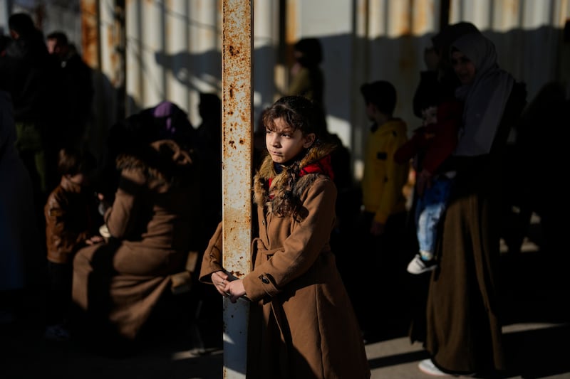 Syrians wait to cross into Syria from Turkey at the Oncupinar border gate, near the town of Kilis, southern Turkey (Khalil Hamra/AP)