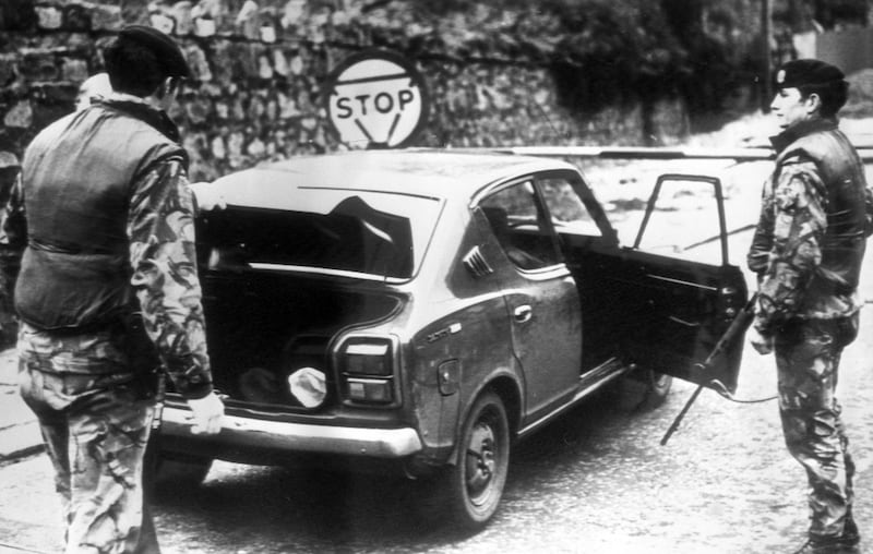 British soldiers search a car at the South Armagh border in the wake of the massacre of 10 Protestant workers at Kingsmills in 1976