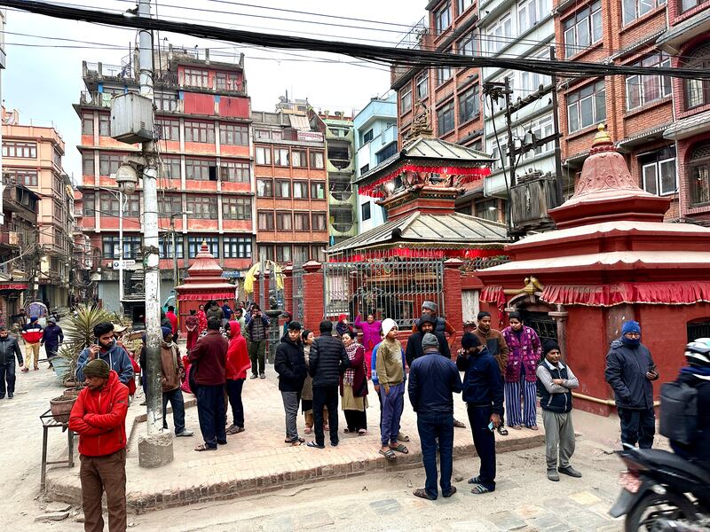 Nepalese people stand after rushing out of their homes after experiencing an earthquake in Kathmandu, Nepal (Sunil Sharma/AP)