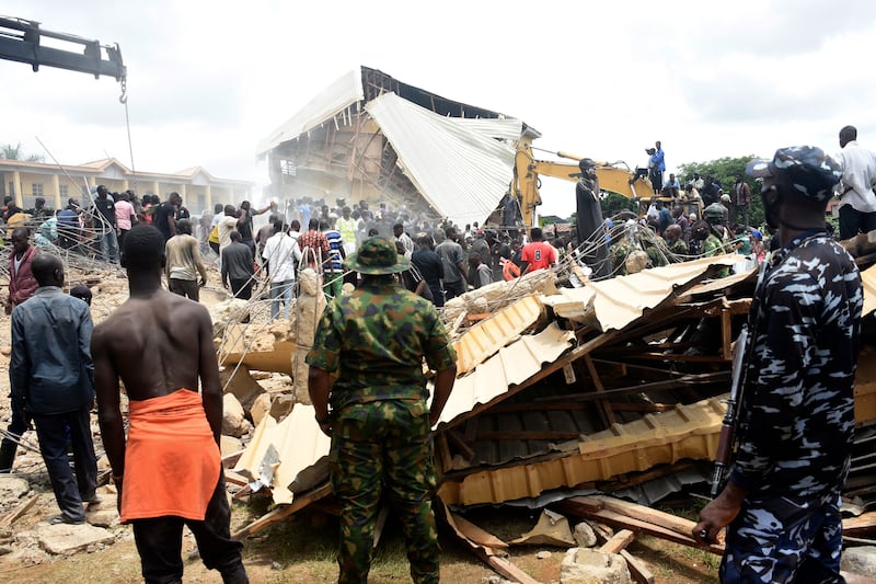 People gather at the scene of the collapse (AP)