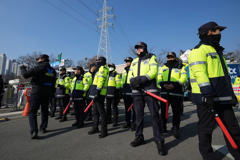 Police officers stand guard outside of the detention centre where President Yoon Suk Yeol is being held in Uiwang (Lee Jin-man/AP)