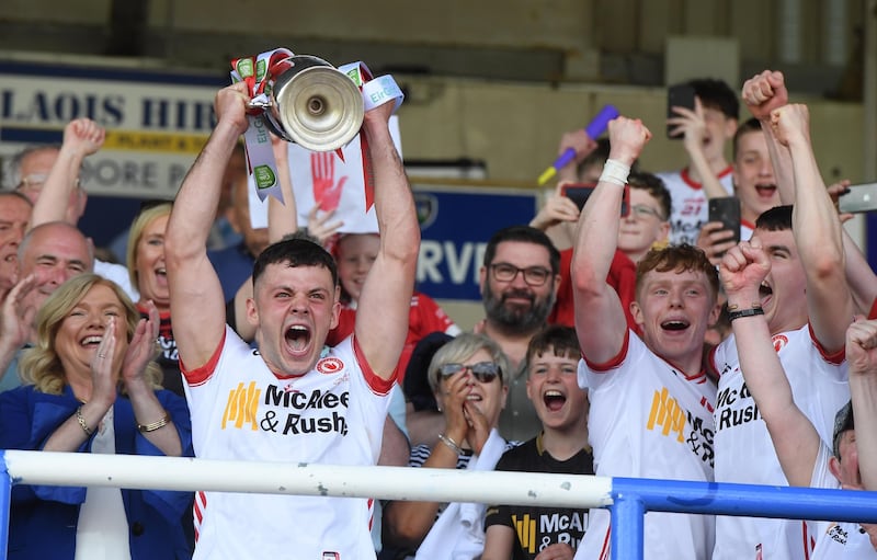 Michael Rafferty lifts the All-Ireland under-20 title with his Tyrone teammates on Sunday. Pictured over his left shoulder is Niall McKenna, chairman of the ‘Enough is Enough’ campaign group, set up in the aftermath of John Rafferty’s death in October 2022.