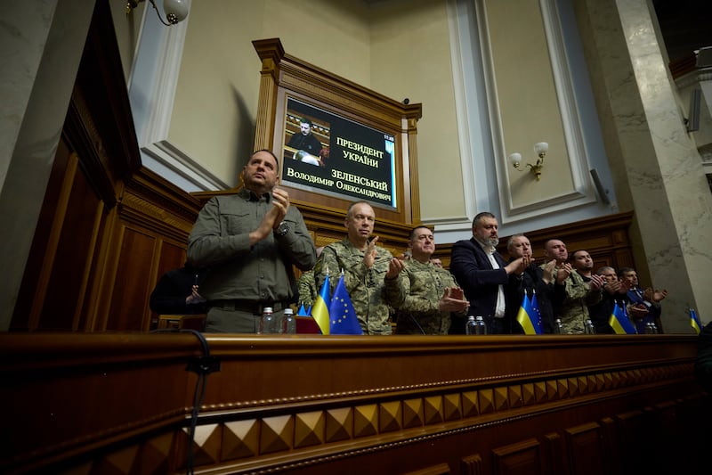 People listen to the speech by Volodymyr Zelensky (Press Service Of The President Of Ukraine via AP)