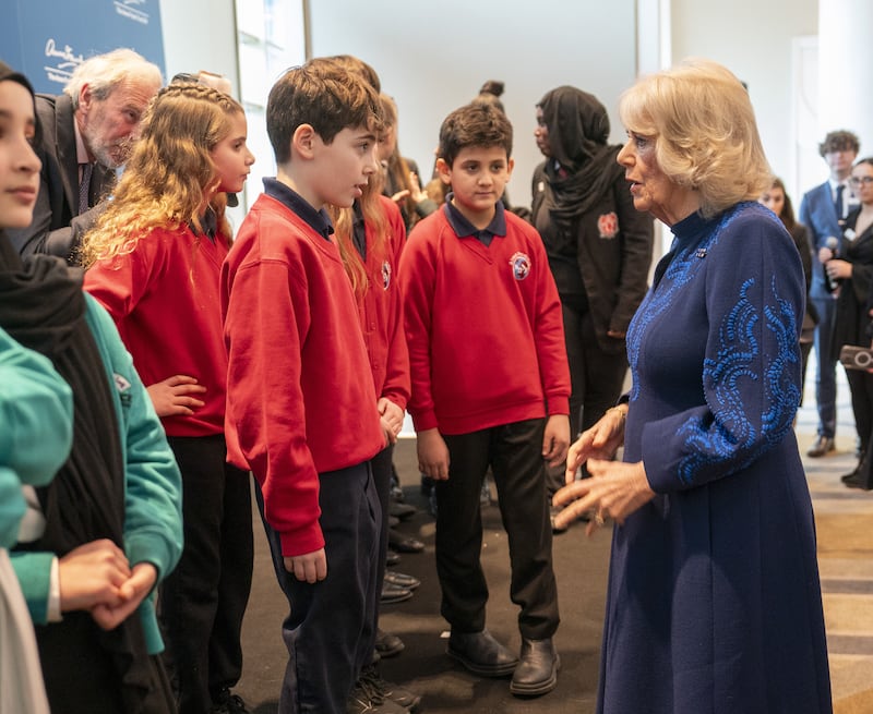 Queen Camilla speaks to children, during a reception hosted by the Anne Frank Trust to mark Holocaust Memorial Day