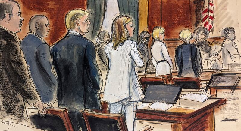 Prospective jurors file into the courtroom as Donald Trump, third left, stands surrounded by his defence team (Elizabeth Williams/AP)