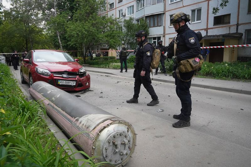 Police officers inspect part of a Russian missile that fell close to an apartment building in Kharkiv, Ukraine (AP Photo/Andrii Marienko)
