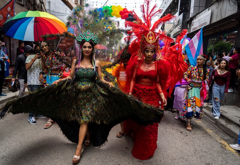 The Gai Jatra festival is held to remember family members who have died during the year but involves colourful parades that sexual minorities join in with (Niranjan Shrestha/AP)