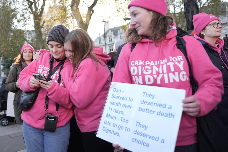 Supporters of Dignity in Dying celebrate on hearing the result of the vote on the Terminally Ill Adults (End of Life) Bill, outside the Houses of Parliament