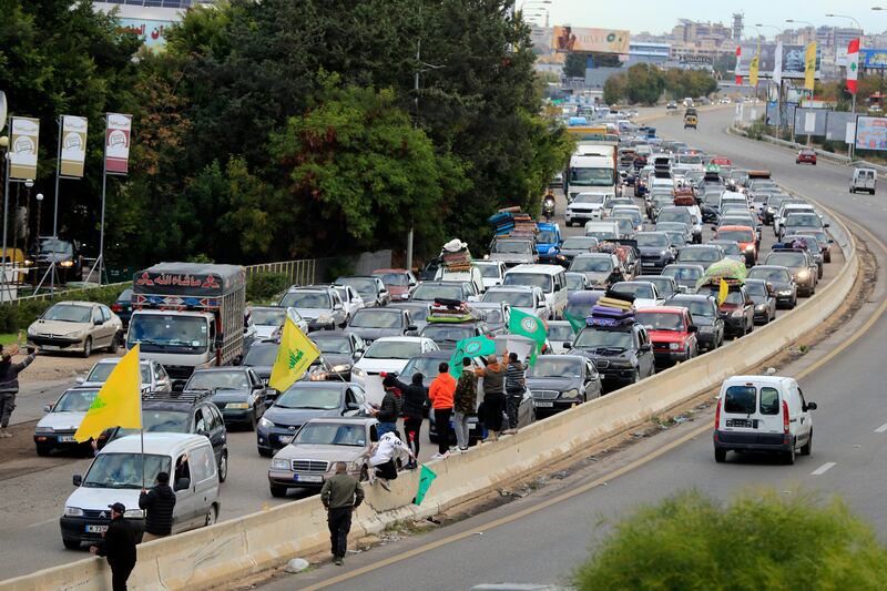 People sit in traffic as they return to their villages after a ceasefire between Israel and Hezbollah went into effect in Ghazieh, Lebanon (Mohammed Zaatari/AP)