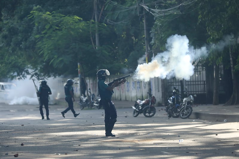 Police fire tear gas shells and rubber bullets to disperse students at the university campus in Dhaka (Rajib Dhar/AP)