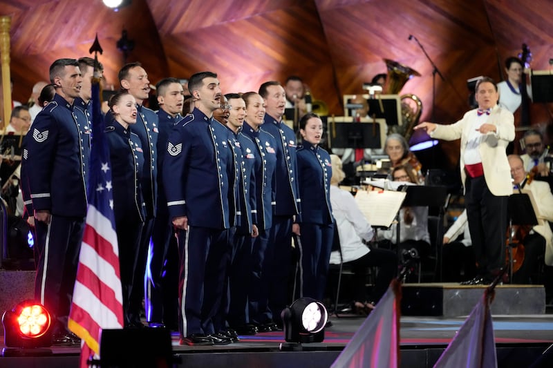 The Singing Sergeants sing the national anthem as Keith Lockhart, right, conducts during the Boston Pops Fireworks Spectacular at the Hatch Memorial Shell on the Esplanade in Boston (Michael Dwyer/AP)