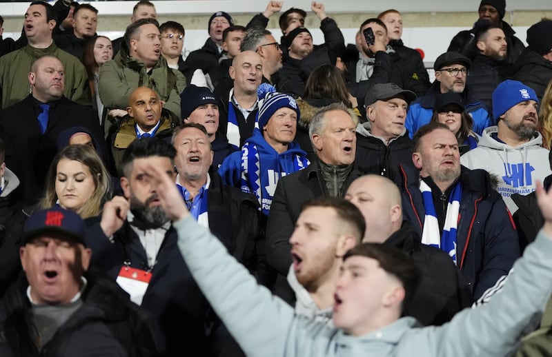 Birmingham’s American chairman Tom Wagner (centre, blue club bobble hat and scarf) was in the away end